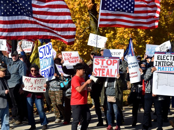 WILKES-BARRE, PENNSYLVANIA, UNITED STATES - 2020/11/06: Protesters holding placards, waving flags as they chant slogans during the demonstration.Over 100 protesters came out to demonstrate at the elections board after Joe Biden overtook President Trump in Pennsylvania during the vote count. Protesters argue that any vote received after November 3 should not be counted. (Photo by Aimee Dilger/SOPA Images/LightRocket via Getty Images)