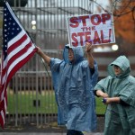 WILKES-BARRE, PENNSYLVANIA, UNITED STATES - 2020/11/11: A protester holds a placard and a flag during the demonstration.A group of approximately 25 people in support of Donald Trump marched around Public Square shouting "Stop the Steal" and demanding a recount of votes in Pennsylvania. (Photo by Aimee Dilger/SOPA Images/LightRocket via Getty Images)