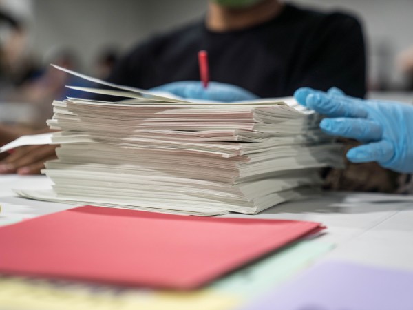 LAWRENCEVILLE, GA - NOVEMBER 16: Gwinnett County election workers handle ballots as part of the recount for the 2020 presidential election at the Beauty P. Baldwin Voter Registrations and Elections Building on November 16, 2020 in Lawrenceville, Georgia. Officials are hoping to finish the hand counting of ballots before the deadline on November 18. There has not been declared a winner in Georgia, where President-elect Joe Biden leads President Donald Trump by 0.3 percentage points.(Photo by Megan Varner/Getty Images)
