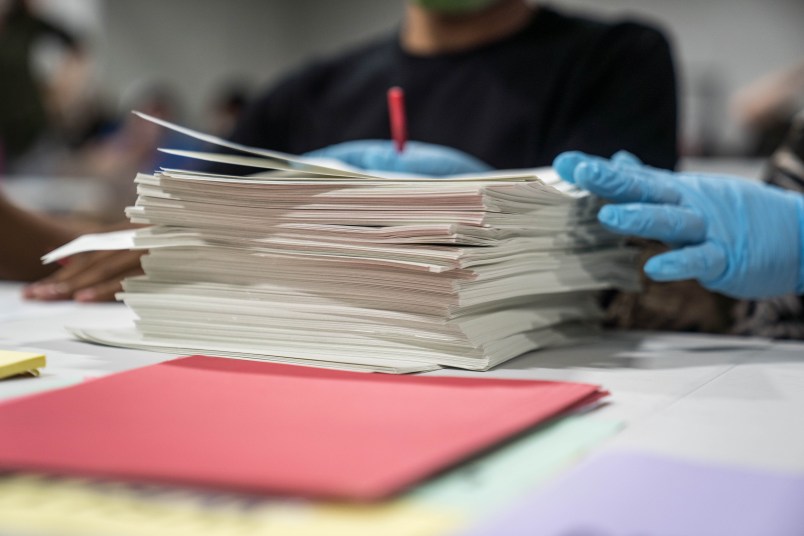 LAWRENCEVILLE, GA - NOVEMBER 16: Gwinnett County election workers handle ballots as part of the recount for the 2020 presidential election at the Beauty P. Baldwin Voter Registrations and Elections Building on November 16, 2020 in Lawrenceville, Georgia. Officials are hoping to finish the hand counting of ballots before the deadline on November 18. There has not been declared a winner in Georgia, where President-elect Joe Biden leads President Donald Trump by 0.3 percentage points.(Photo by Megan Varner/Getty Images)