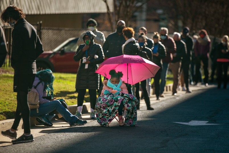 ATLANTA, GA - DECEMBER 14: Voters wait in a long line to vote at the Buckhead library in Atlanta on the first day of In-person early voting for the Georgia Senate runoff election on Monday, Dec. 14, 2020 in Atlanta, GA. (Jason Armond / Los Angeles Times)