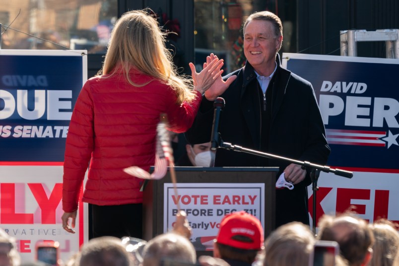 MILTON, GA - DECEMBER 21: Senators Kelly Loeffler and David Perdue high five each other as Perdue takes the stage to speak during a campaign event on December 21, 2020 in Milton, Georgia. The two Georgia U.S. Senate runoff elections on Jan. 5 will decide control of the Senate. (Photo by Elijah Nouvelage/Getty Images)