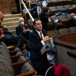 UNITED STATES - JANUARY 6: Rep. Jason Crow, D-Colo.,  and other members take cover as protesters attempt to disrupt the joint session of Congress to certify the Electoral College vote on Wednesday, January 6, 2021. (Photo By Tom Williams/CQ Roll Call)