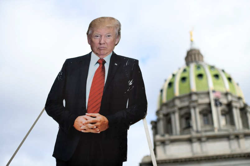 HARRISBURG, PA - JANUARY 17: A cardboard effigy of President Donald Trump is lowered while people demonstrate against the president outside the Pennsylvania Capitol Building on January 17, 2021 in Harrisburg, Pennsylvania. Supporters of President Trump are expected to gather at state capitol buildings throughout the nation today to protest the presidential election results and the upcoming inauguration of President-elect Joe Biden. (Photo by Mark Makela/Getty Images)