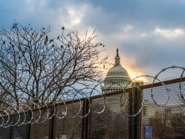 WASHINGTON, DISTRICT OF COLUMBIA, UNITED STATES - 2021/01/23: Razor wire and fences still surround the United States Capitol building at sunrise a few days after the inauguration of President Joe Biden and Vice President Kamala Harris. The Capitol was breached during an insurrection January 6 just days before the inauguration. (Photo by Jeremy Hogan/SOPA Images/LightRocket via Getty Images)
