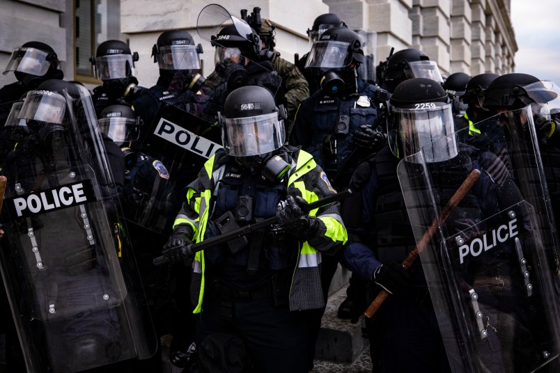 WASHINGTON, DC - JANUARY 06: Police officers attempt to push back pro-Trump supporters that are trying to storm the US Capitol following a rally with President Donald Trump on January 6, 2021 in Washington, DC. Trump supporters gathered in the nation's capital today to protest the ratification of President-elect Joe Biden's Electoral College victory over President Trump in the 2020 election. (Photo by Samuel Corum/Getty Images)