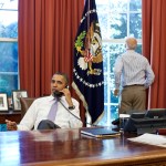 Vice President Joe Biden looks out the window as President Barack Obama talks on the phone with House Speaker John Boehner in the Oval Office to discuss ongoing efforts in the debt limit and deficit reduction talks, Sunday, July 31, 2011. (Official White House Photo by Pete Souza)This official White House photograph is being made available only for publication by news organizations and/or for personal use printing by the subject(s) of the photograph. The photograph may not be manipulated in any way and may not be used in commercial or political materials, advertisements, emails, products, promotions that in any way suggests approval or endorsement of the President, the First Family, or the White House.