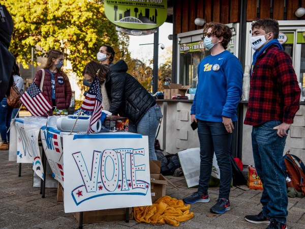 PITTSBURGH, UNITED STATES - 2020/11/03: University of Pittsburgh students with Biden/Harris signs and stickers.On the University of Pittsburgh campus many students organizing get out the vote campaigns through signs, stickers, and text messaging their friends during the United States Election Day. (Photo by Aaron Jackendoff/SOPA Images/LightRocket via Getty Images)