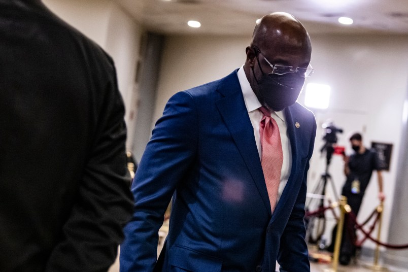 WASHINGTON, DC - FEBRUARY 13: Senator Raphael Warnock (D-GA) walks through the Senate subway before the start of the fourth day in the Senates second impeachment trial of former President Donald Trump on February 13, 2021 in Washington, DC. The Senate voted 55-45 in favor of calling witnesses in the trial to decide on if Trump should or should not be held responsible for the January 6th attack at the U.S. Capitol. (Photo by Samuel Corum/Getty Images) *** Local Caption *** Raphael Warnock