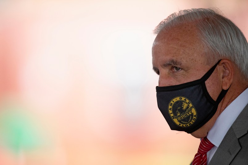 Miami-Dade County Mayor Carlos Gimenez looks on at the COVID-19 drive-thru testing center at Miami-Dade County Auditorium in Miami on Thursday, July 23, 2020. (David Santiago/Miami Herald/TNS)