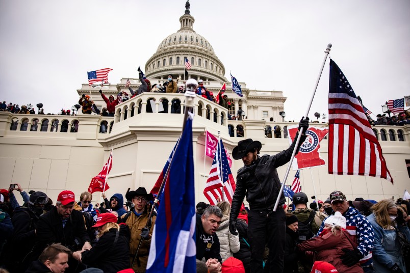 WASHINGTON, DC - JANUARY 06: Pro-Trump supporters storm the US Capitol following a rally with President Donald Trump on January 6, 2021 in Washington, DC. Trump supporters gathered in the nation's capital today to protest the ratification of President-elect Joe Biden's Electoral College victory over President Trump in the 2020 election. (Photo by Samuel Corum/Getty Images)