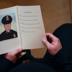 WASHINGTON, DC - FEBRUARY 3: A U.S. Capitol Police Officer holds a program for the ceremony memorializing U.S. Capitol Police Officer Brian D. Sicknick, 42, as he lies in honor in the Rotunda of the Capitol on Wednesday, February 3, 2021. Officer Sicknick was responding to the riot at the U.S. Capitol on Wednesday, January 6, 2021, when he was fatally injured while physically engaging with the mob. Members of Congress will pay tribute to the officer on Wednesday morning before his burial at Arlington National Cemetery. (Photo by Demetrius Freeman/The Washington Post/POOL)