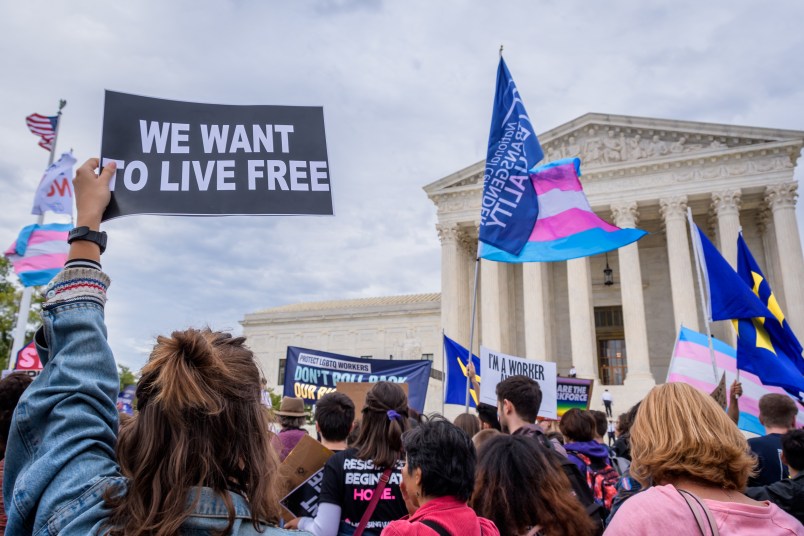 WASHINGTON DC, UNITED STATES - 2019/10/08: Participant holding a sign outsithe the Supreme Court. 133 protesters were arrested blocking the street across the Supreme Court in an act of non violent civil disobedience, as hundreds of LGBTQ+ advocates convened in Washington, DC for a national day of action as a community response to the landmark Supreme Court hearings that could legalize workplace discrimination, primarily against LGBTQ+ people, on the basis of sexual orientation, gender identity, and gender presentation. (Photo by Erik McGregor/LightRocket via Getty Images)