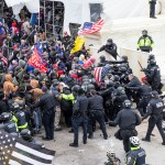 WASHINGTON DC, DISTRICT OF COLUMBIA, UNITED STATES - 2021/01/06: Pro-Trump protesters and police clash on top of the Capitol building. Rioters broke windows and breached the Capitol building in an attempt to overthrow the results of the 2020 election. Police used batons and tear gas grenades to eventually disperse the crowd. Rioters used metal bars and tear gas as well against the police. (Photo by Lev Radin/Pacific Press/LightRocket via Getty Images)