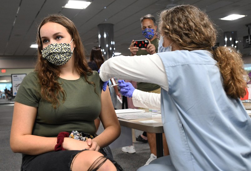 MELBOURNE, FLORIDA, UNITED STATES - 2021/05/17: A nurse gives Sherri Trimble, 15, a shot of the vaccine at a vaccination clinic at Health First Medical Centre.On May 12, 2021, the CDC approved the use of the Pfizer BioNTech vaccine in 12 through 15-year-old adolescents. Vaccinating this age group is seen as a keyway for middle and high schools to reopen fully by this fall. (Photo by Paul Hennessy/SOPA Images/LightRocket via Getty Images)