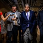 WASHINGTON, DC - JULY 26: U.S. Sen. Joe Manchin (D-WV) is followed by a swarm of reporters as he leaves a meeting between a group of bipartisan Senators in the basement of the U.S. Capitol Building on July 26, 2021 in Washington, DC. The group of Senators are trying to come to an agreement on the Infrastructure Bill before Congress heads into their August recess after the initial agreement fell apart. (Photo by Samuel Corum/Getty Images) *** Local Caption *** Joe Manchin