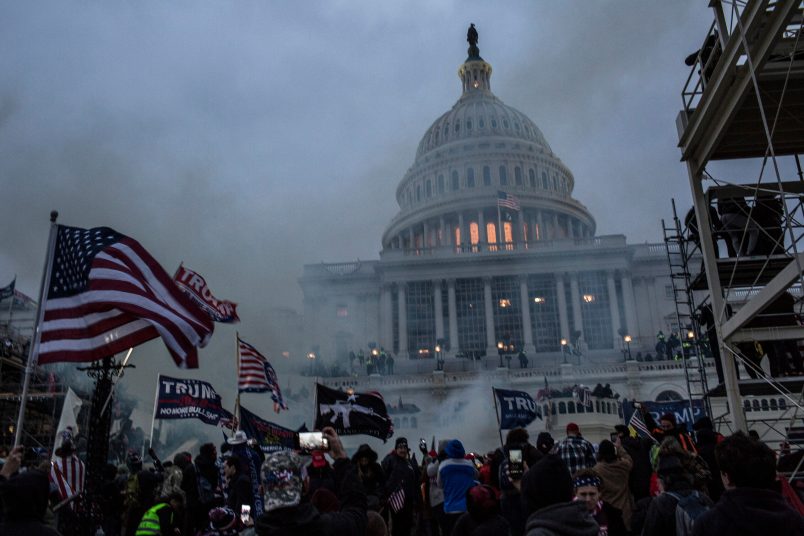 WASHINGTON, DISTRICT OF COLUMBIA, UNITED STATES - 2021/01/06: Security forces respond with tear gas after the US President Donald Trump's supporters breached the US Capitol security. Pro-Trump rioters stormed the US Capitol as lawmakers were set to sign off Wednesday on President-elect Joe Biden's electoral victory in what was supposed to be a routine process headed to Inauguration Day. (Photo by Probal Rashid/LightRocket via Getty Images)