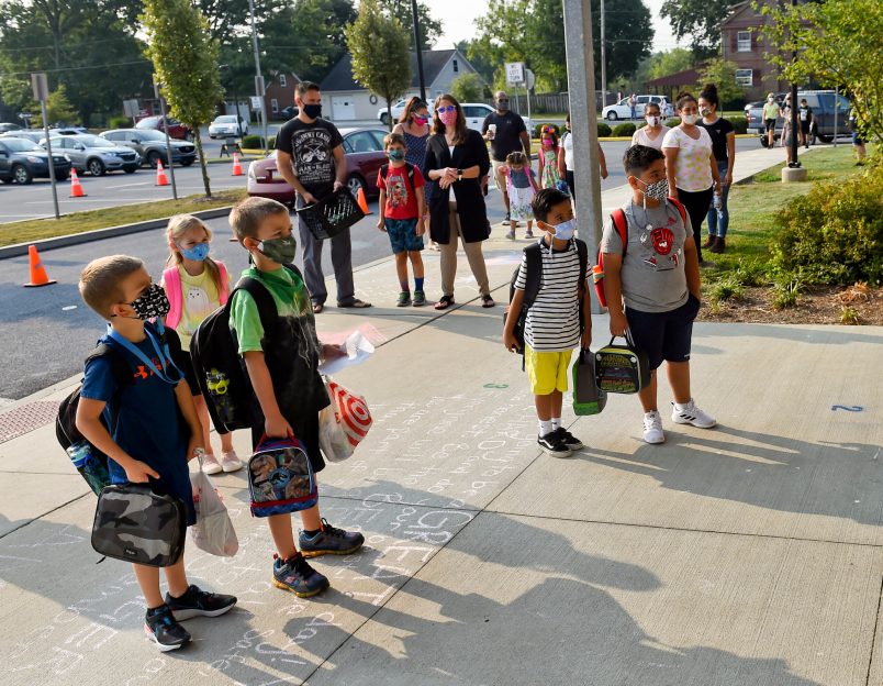 Students and parents wait outside Perry Elementary School on the first day of school. At Perry Elementary School in Shoemakersville, PA Thursday morning August 27, 2020 for the first day of in person school of the school year. The Hamburg School District, which Perry Elementary is part of, is the only school district in Berks County that is opening 5 days a week for in person instruction during the coronavirus / COVID-19 outbreak.