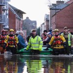 YORK, ENGLAND - DECEMBER 27: Members of Cleveland Mountain Rescue and soldiers from 2 Battalion The Duke of Lancasters Regiment assist members of the public as they are evacuated from the Queens Hotel in York city centre as the River Ouse floods on December 27, 2015 in York, England. Heavy rain over the Christmas period has caused severe flooding in parts of northern England, with homes and businesses in Yorkshire and Lancashire evacuated as water levels continue to rise in many parts. (Photo by Ian Forsyth/Getty Images)