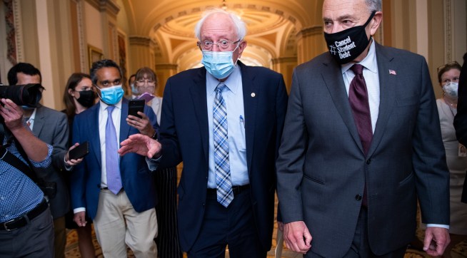 UNITED STATES - AUGUST 9: Senate Majority Leader Charles Schumer, D-N.Y., right, and Sen. Bernie Sanders, I-Vt., are seen in the U.S. Capitol on Monday, August 9, 2021. (Photo By Tom Williams/CQ Roll Call)