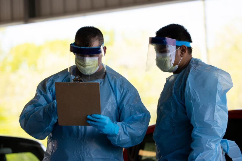 SPRINGFIELD, TN - APRIL 18:  Medical personnel work at a drive thru coronavirus (covid-19) testing site at Robertson County Fairgrounds on April 18, 2020 in Springfield, Tennessee. Tennessee drive thru testing sites now allow those without symptoms of coronavirus (covid-19) to receive testing. (Photo by Brett Carlsen/Getty Images)