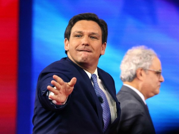 Florida Gov. Ron DeSantis tosses hats into the crowd as he takes the stage at the 2022 CPAC conference at the Rosen Shingle Creek in Orlando, Florida, on Thursday, Feb. 24, 2022. (Joe Burbank/Orlando Sentinel/Tribune News Service via Getty Images)